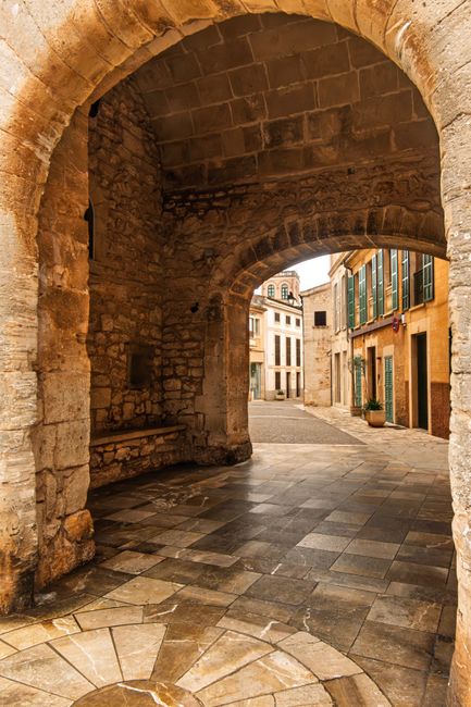 Discover the rustic charm of Santanyí's historic stone architecture through this inviting archway.